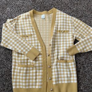 Cardigan sweater. Tag was cut out because it itches.